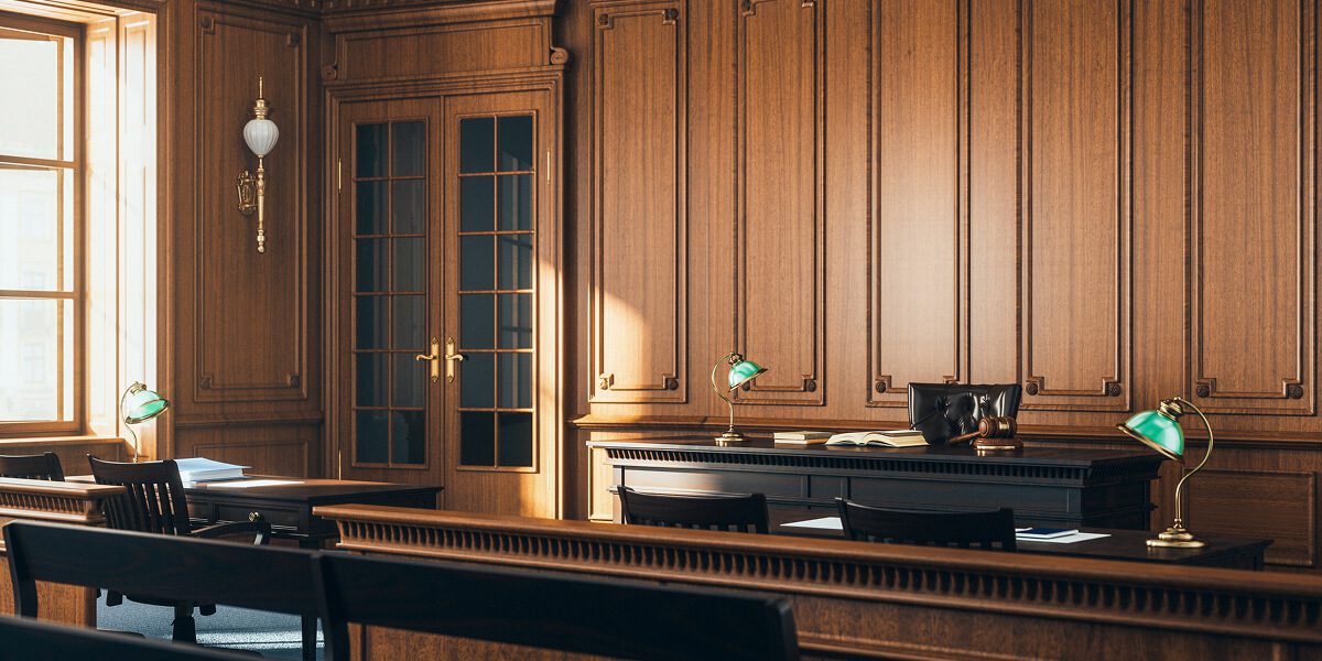 Empty wooden courtroom with green lamps.