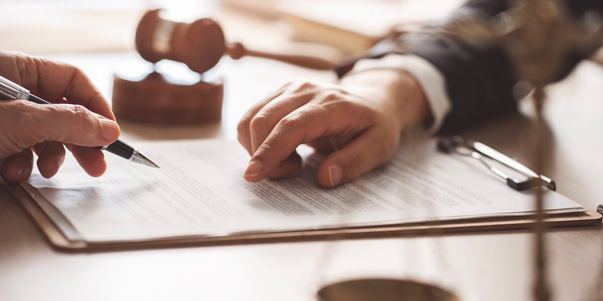 Lawyers reviewing documents at a desk.